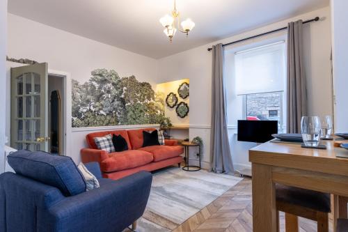 a living room with two chairs and a couch at The Wee Gem in Inverness