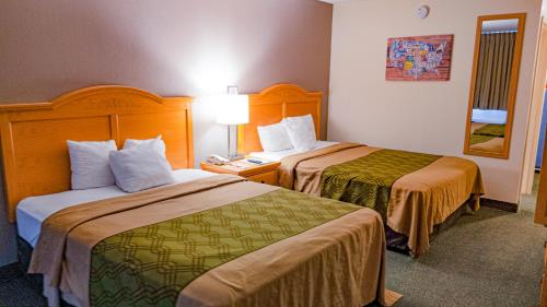 a hotel room with two beds and a phone at Econo Lodge Rawlins in Rawlins