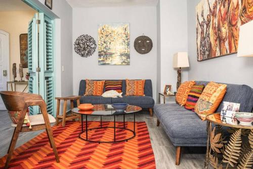 a living room with a couch and a table at Renovated Condo at the Beach Close to Everything in Las Terrenas