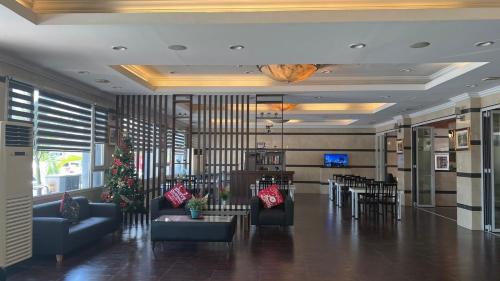 a lobby with couches and tables in a building at Vera Hotel in Angeles