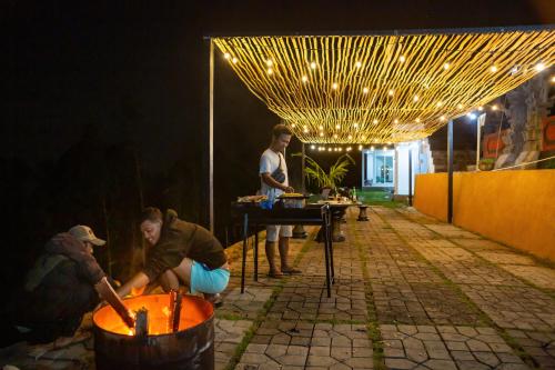 a group of people preparing food on a patio at night at Alam Nirwana in Gretek