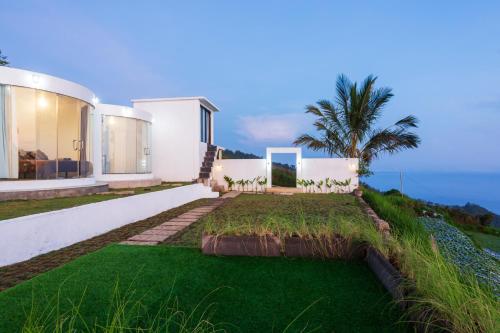 a house with a grass yard in front of it at Alam Nirwana in Gretek
