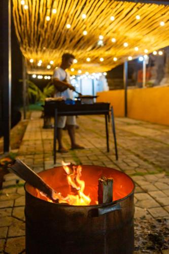 a man standing in front of a fire pit at Alam Nirwana in Gretek