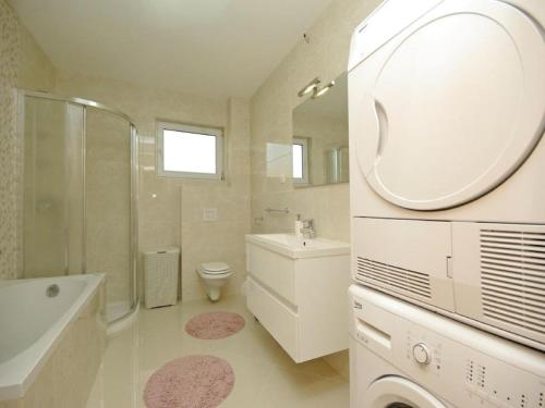 a bathroom with a sink toilet and a mirror at Villa in Croatia near Blue & Red Lakes in Imotski