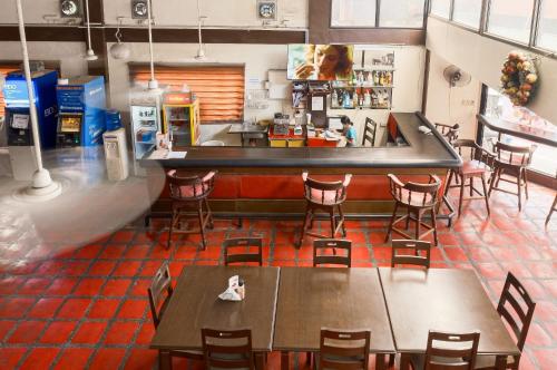 a restaurant with tables and chairs and a counter at Orchid Inn in Angeles