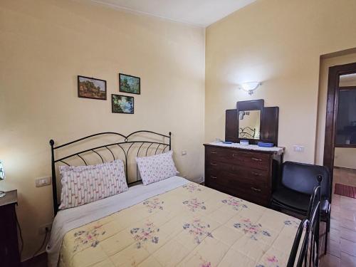 a bedroom with a bed and a dresser and a mirror at Apartment in Umbria near Montefalco Winery in Giano dellʼUmbria