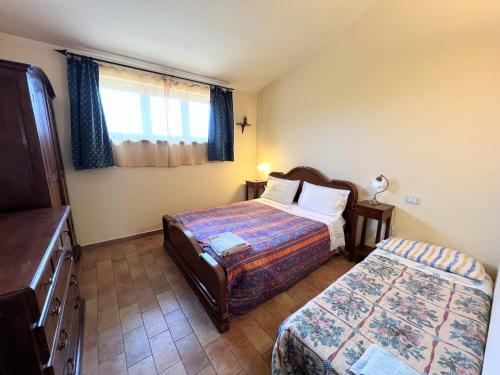 a hotel room with two beds and a window at Apartment in Umbria near Montefalco Winery in Giano dellʼUmbria
