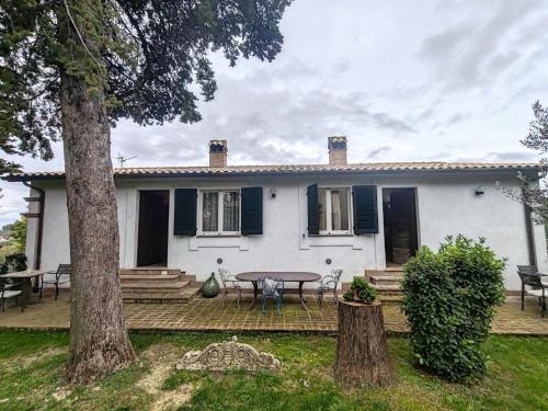 a white house with a table in front of it at Apartment in Umbria near Montefalco Winery in Giano dellʼUmbria