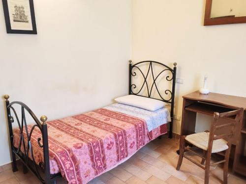 a bedroom with a bed and a table and a chair at Farmhouse in Giano dell'Umbria in Giano dellʼUmbria
