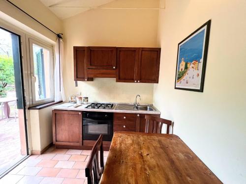 a kitchen with a wooden table and a stove top oven at Farmhouse in Giano dell'Umbria in Giano dellʼUmbria