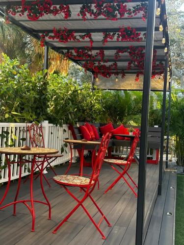 a table and chairs under a pergola on a deck at Prestige Collection, Hotel Boutique in St Petersburg