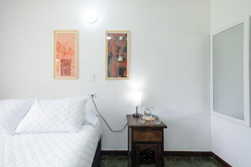 a bedroom with a bed and a table with a phone at Hotel Chalet La Sofia by Majuva in Armenia
