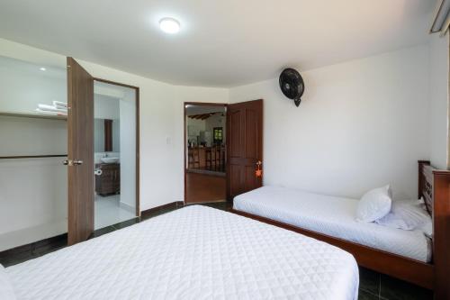 a bedroom with two beds and a mirror at Hotel Chalet La Sofia by Majuva in Armenia