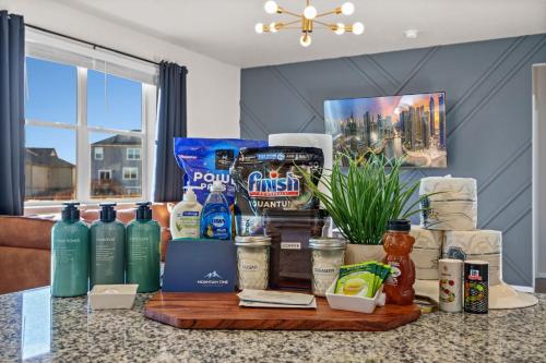 a table with a bunch of food and drinks on it at Mountain View Home with King Beds and Rooftop Deck in Fort Collins