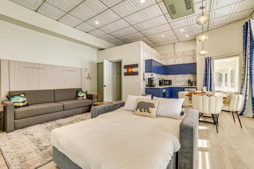 a living room with a large bed and a kitchen at Keystone Lake Haven Heated Pool and Ski Shuttle! in Keystone