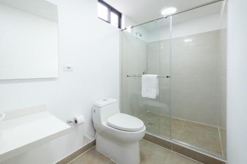 a bathroom with a toilet and a glass shower at Hotel Chalet La Sofia by Majuva in Armenia