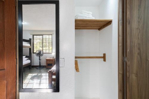 a mirror on a wall next to a room at Hotel Chalet La Sofia by Majuva in Armenia