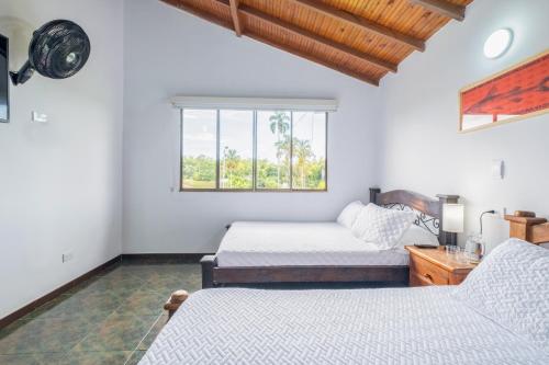 a bedroom with two beds and a window at Hotel Chalet La Sofia by Majuva in Armenia