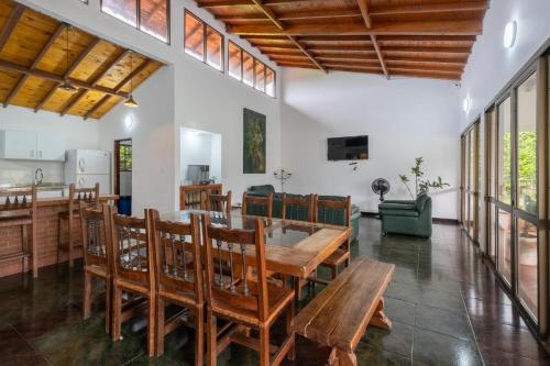 a dining room with a wooden table and chairs at Hotel Chalet La Sofia by Majuva in Armenia