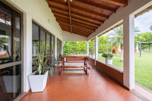a porch with a wooden table and a bench at Hotel Chalet La Sofia by Majuva in Armenia