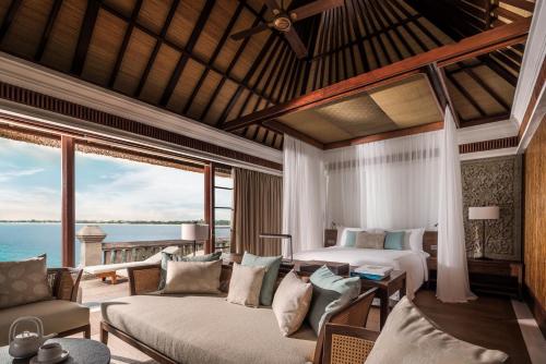 a bedroom with two beds and a view of the ocean at Four Seasons Resort Bali at Jimbaran Bay in Jimbaran