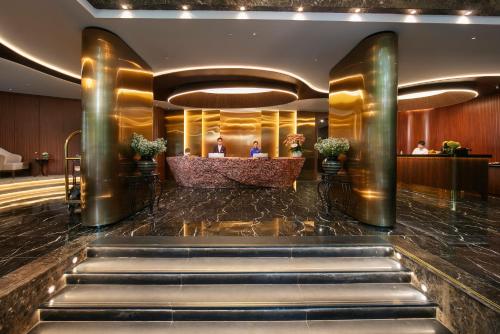 a lobby of a hotel with stairs leading to a reception at MAY DE VILLE Corner Hotel in Hanoi