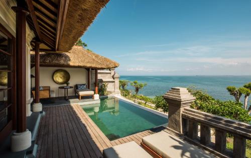 a villa with a swimming pool and a view of the ocean at Four Seasons Resort Bali at Jimbaran Bay in Jimbaran
