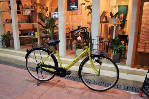 a yellow bike parked in front of a store at Sato-san's Rest in Tokyo