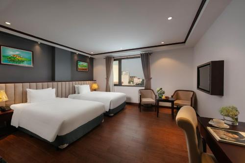 a hotel room with two beds and a television at MAY DE VILLE Corner Hotel in Hanoi