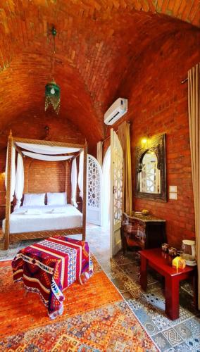 a bedroom with a bed in a brick wall at Luxor Tower in Luxor