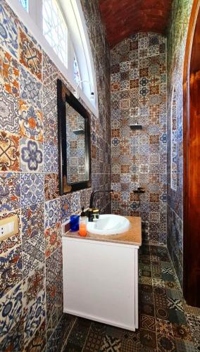 a bathroom with a sink and a tile wall at Luxor Tower in Luxor