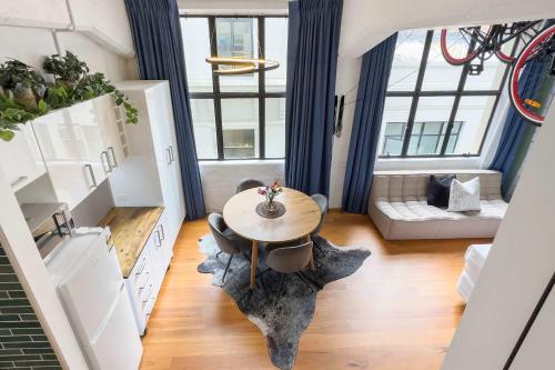 a living room with a table and a couch at Studio Loft Apartment w bikes Wifi CBD in Auckland