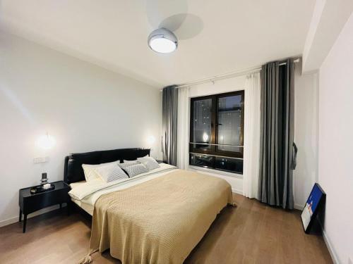 Bund Branch New west door 2 bedrooms big house في شانغهاي: غرفة نوم بسرير كبير ونافذة