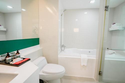 a bathroom with a toilet and a shower at SLEEP WITH ME HOTEL design hotel @ patong (SHA Plus+) in Patong Beach