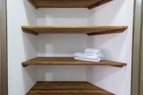 a towel rack in a bathroom with wooden shelves at Hotel Chalet La Sofia by Majuva in Armenia