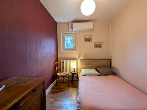 une chambre avec deux lits et un bureau et une fenêtre dans l'établissement Maison de campagne calme avec jardin, proche du Zoo de Beauval et châteaux de la Loire - FR-1-591-84, à Poulaines