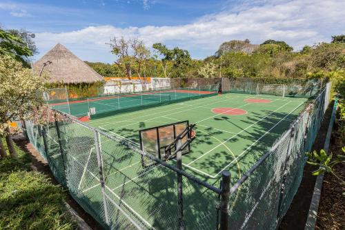 a tennis court with a net on top of it at Grand Palladium Vallarta Resort & Spa - All Inclusive in Punta Mita