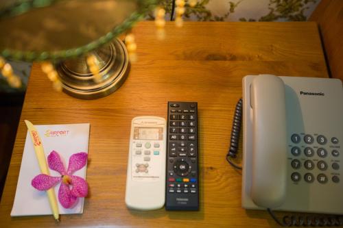 a table with a phone and a calculator on it at The Airport Hotel in Ho Chi Minh City