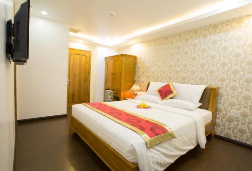 a bedroom with a large bed and a television at The Airport Hotel in Ho Chi Minh City