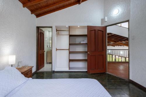 a bedroom with a bed and a closet with shelves at Hotel Chalet La Sofia by Majuva in Armenia