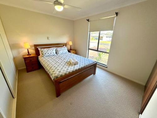 a small bedroom with a bed and a window at Bignell Family Home-Stay in Broadwater