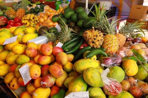 a display of fruits and vegetables in a market at kehena black sand beach house - ocean view swim spa in Pahoa
