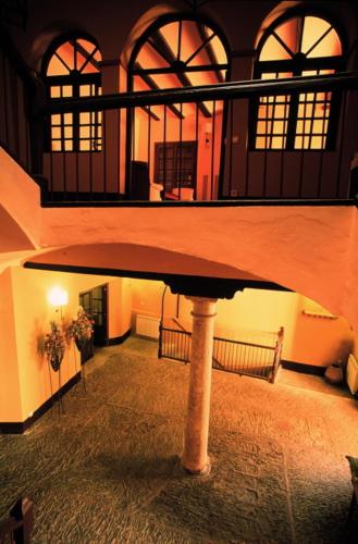 a large building with a staircase in a room at Posada del Almudí in Daroca