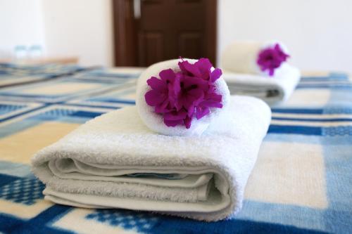 a pile of towels with a flower on top of them at Dalyan Garden Pension in Dalyan