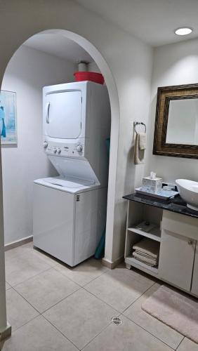 a white refrigerator in a kitchen with a sink at Solarium Studio Apartment at Coronado Bay Oceanfront in Playa Coronado