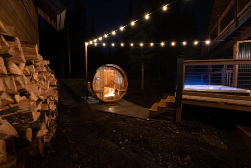 a wooden barrel with lights on the side of a building at Winston Lodge in Golden