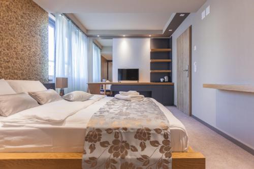 a bedroom with a large bed in a room at Plaza Hotel Winterthur in Winterthur