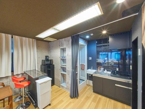 a kitchen with a sink and a counter top at Shimbashi Hotel Sho in Tokyo