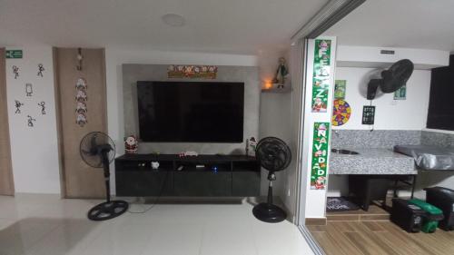 a living room with a flat screen tv and a living room at Apartamento en Ricaurte para descansar y disfrutar in Ricaurte