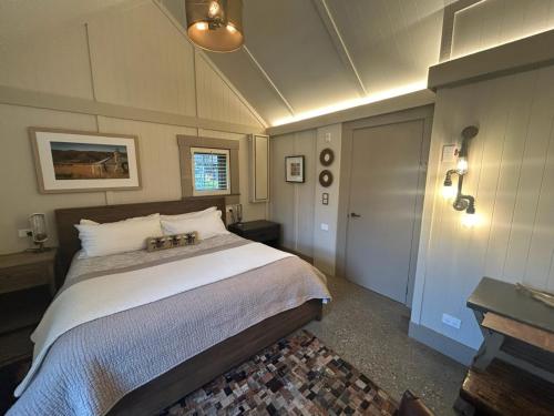 a bedroom with a large bed and a door at The Headwaters Eco Lodge in Glenorchy